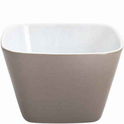 Eine quadratische Schüssel aus Keramik mit einem matten, grauen Äußeren und einem glatten, weißen Innenraum. Die Schüssel hat leicht abgerundete Ecken und steht auf einer ebenen Fläche. Sie eignet sich zum Servieren von Snacks oder als dekoratives Element.