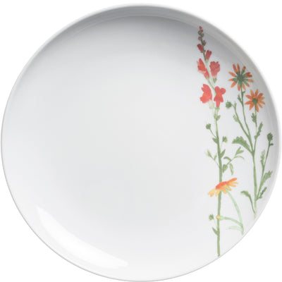 Ein runder, flacher Teller aus weißem Porzellan. Auf der linken Seite des Geschirrs sind stilisierte Blumen in verschiedenen Farben, darunter orange, gelb und rot, abgebildet. Die florale Dekoration verleiht dem Teller eine frische und lebendige Note, während der Rest des Tellers schlicht und unbedruckt bleibt. Ideal als dekoratives Element für jede Tischdekoration oder für den täglichen Gebrauch.