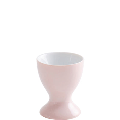 Eine stilvolle, rosa Eierbecher aus Keramik mit glatter Oberfläche. Der Becher hat eine bauchige Form, zeichnet sich durch eine schmale obere Öffnung und einen stabilen, runden Fuß aus. Die Innenseite ist weiß, was einen eleganten Kontrast zur äußeren Farbe bietet. Der Eierbecher steht auf einer neutralen Unterlage.