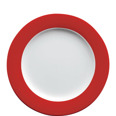 Ein runder Teller mit einem weißen Inneren und einem breiten, roten Rand. Der Teller hat eine glänzende Oberfläche und ist schlicht gestaltet, ohne Verzierungen. Er eignet sich für Servieren von Speisen und hebt sich durch die kontrastreiche Farbkombination hervor.