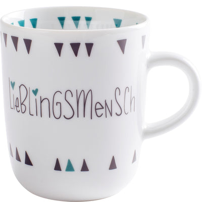 Eine weiße Tasse mit der Aufschrift „Lieblingsmensch“ in geschwungener Schrift. Das Design zeigt kleine, bunten Dreiecke in Türkis und Dunkelviolett, die rund um den oberen Rand der Tasse angeordnet sind. Die Tasse hat einen schlichten, modernen Look und eignet sich ideal für Kaffee oder Tee.