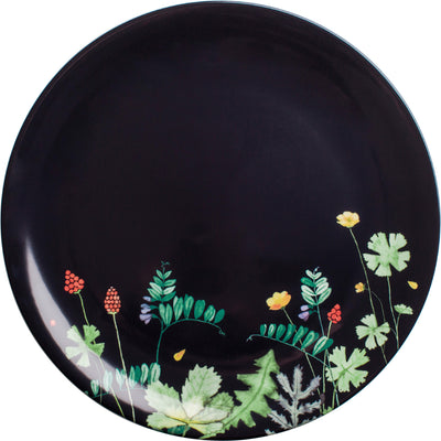 Ein runder, dunkelblauer Teller mit einem floralen Muster. In der unteren Hälfte sind bunte Pflanzen und Blumen abgebildet, darunter grüne Blätter, rote Beeren und gelbe Blüten. Der obere Bereich des Tellers bleibt unifarben und schlicht, wodurch das florale Design gut zur Geltung kommt. Der Teller strahlt eine frische, natürliche Atmosphäre aus.