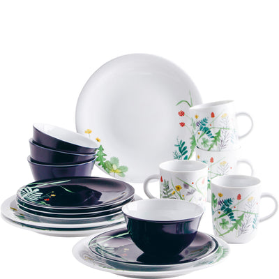 Eine Auswahl an Geschirr, bestehend aus einem großen Teller, mehreren flachen Tellern in dunklem Design, bunten Tassen mit floralen Mustern und einer weißen Schüssel. Das Geschirr ist dekorativ angeordnet und zeigt eine Kombination aus verschiedenen Farben und Designs, ideal für den Tischgedeck.