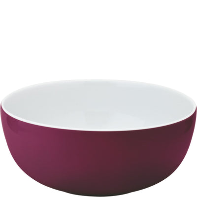 Eine elegante, runde Schüssel mit hohem Rand. Die Außenseite der Schüssel ist in einem kräftigen Violett gehalten, während die Innenseite in einem schlichten Weiß erscheint. Die glatte Oberfläche reflektiert Licht und verleiht der Schüssel einen modernen Look. Ideal für Salate oder Snacks.