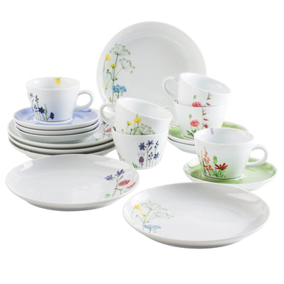 Eine Anordnung von Geschirr, darunter mehrere Tassen mit bunten Blumenmotiven in verschiedenen Farben sowie mehrere Teller. Die Tassen sind teilweise übereinander gestapelt, und einige Teller liegen flach auf einer Oberfläche. Die Geschirrteile sind in einem modernen, klaren Design gehalten und strahlen eine fröhliche Atmosphäre aus.