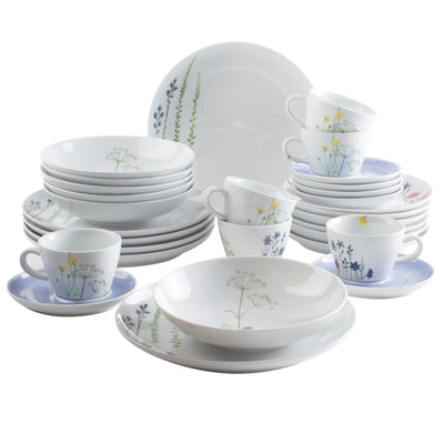 Ein Set von Geschirr besteht aus mehreren Tellern, Schalen und Tassen, die aufeinander gestapelt und angeordnet sind. Die Geschirrteile sind aus weißem Porzellan mit zarten, bunten Blumen- und Pflanzenmotiven verziert. Auf dem Bild sind große und kleine Teller, Suppenschalen sowie Kaffeetassen mit Untertassen zu sehen. Die Anordnung ist harmonisch und übersichtlich, ideal für eine gedeckte Tafel oder den täglichen Gebrauch.
